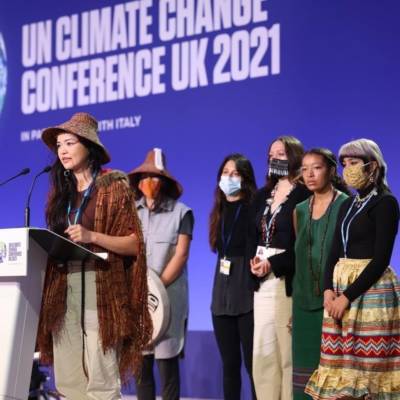 6 Indigenous Young Youth standing on a stage and speaking at COP26
