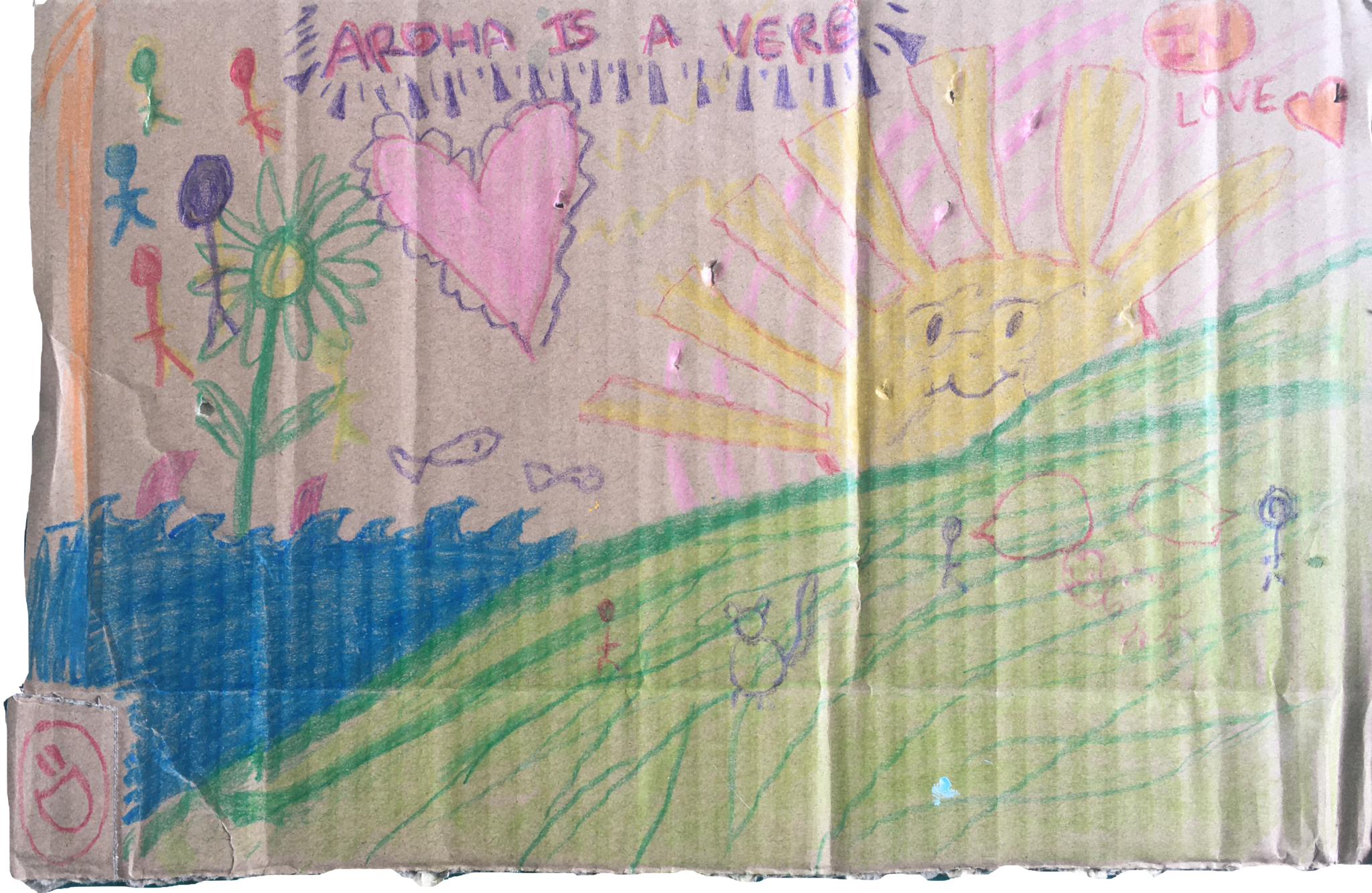 Cardboard art work with hearts flowers and a sunshine on a grassy hill and text that says Aroha