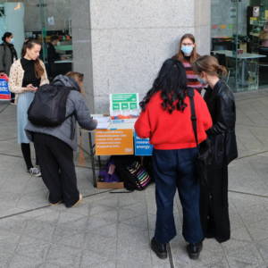 Image of a stall outside of Auckland Council. You can 5 people and a polling booth